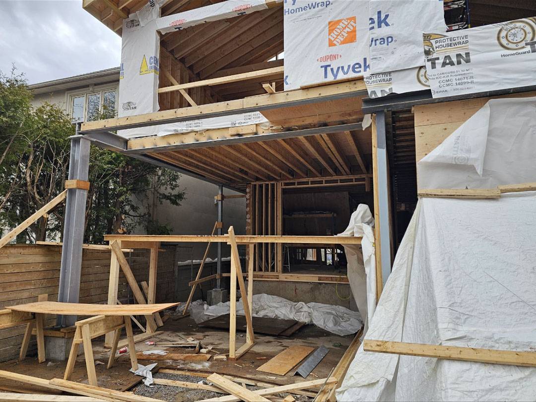 Structural steel column and wood joist framing for a code-compliant residential home addition in Toronto, engineered by PEO-licensed firm StrongBuilds.