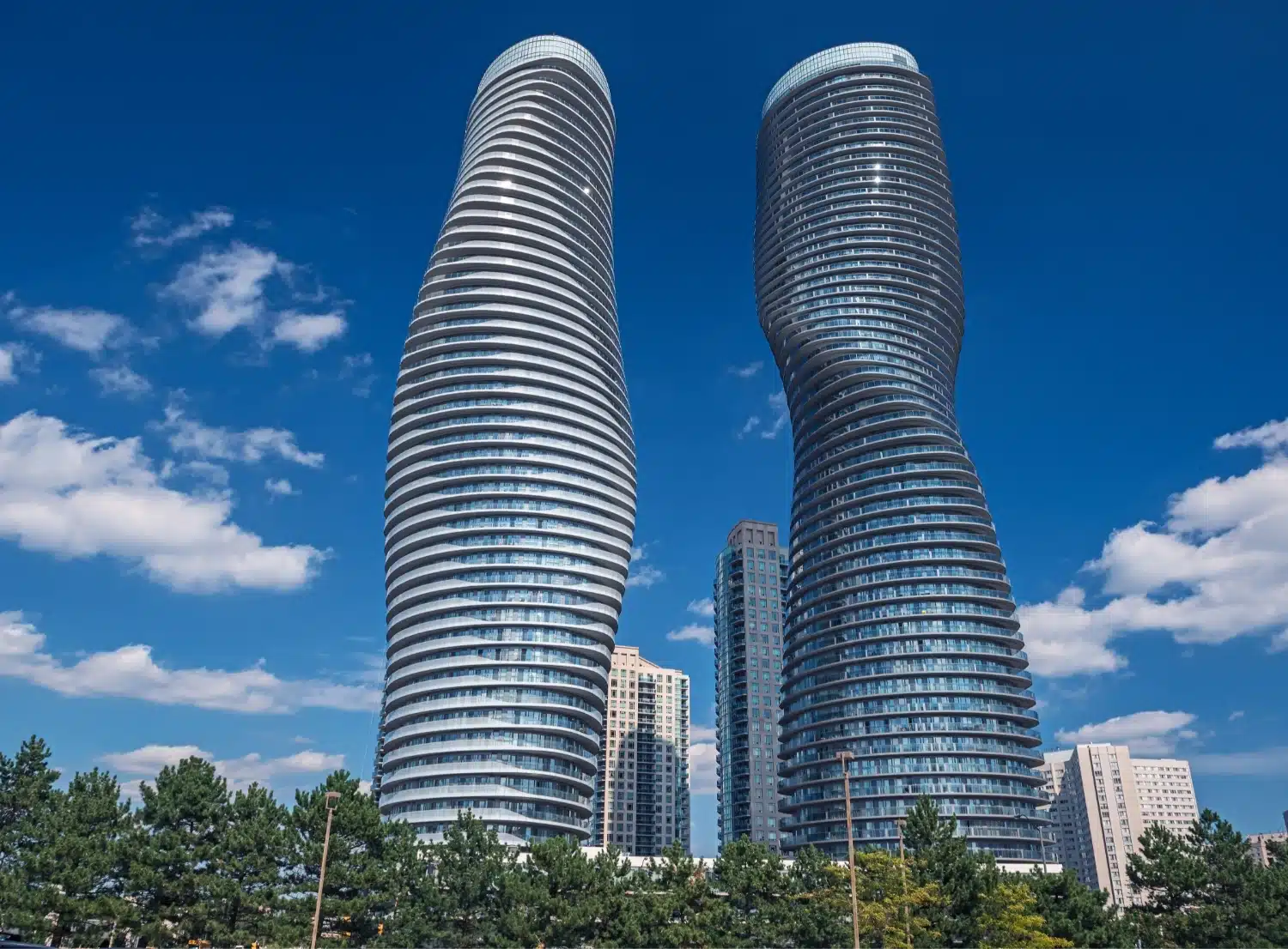 Looking upwards at two modern, curvy skyscrapers