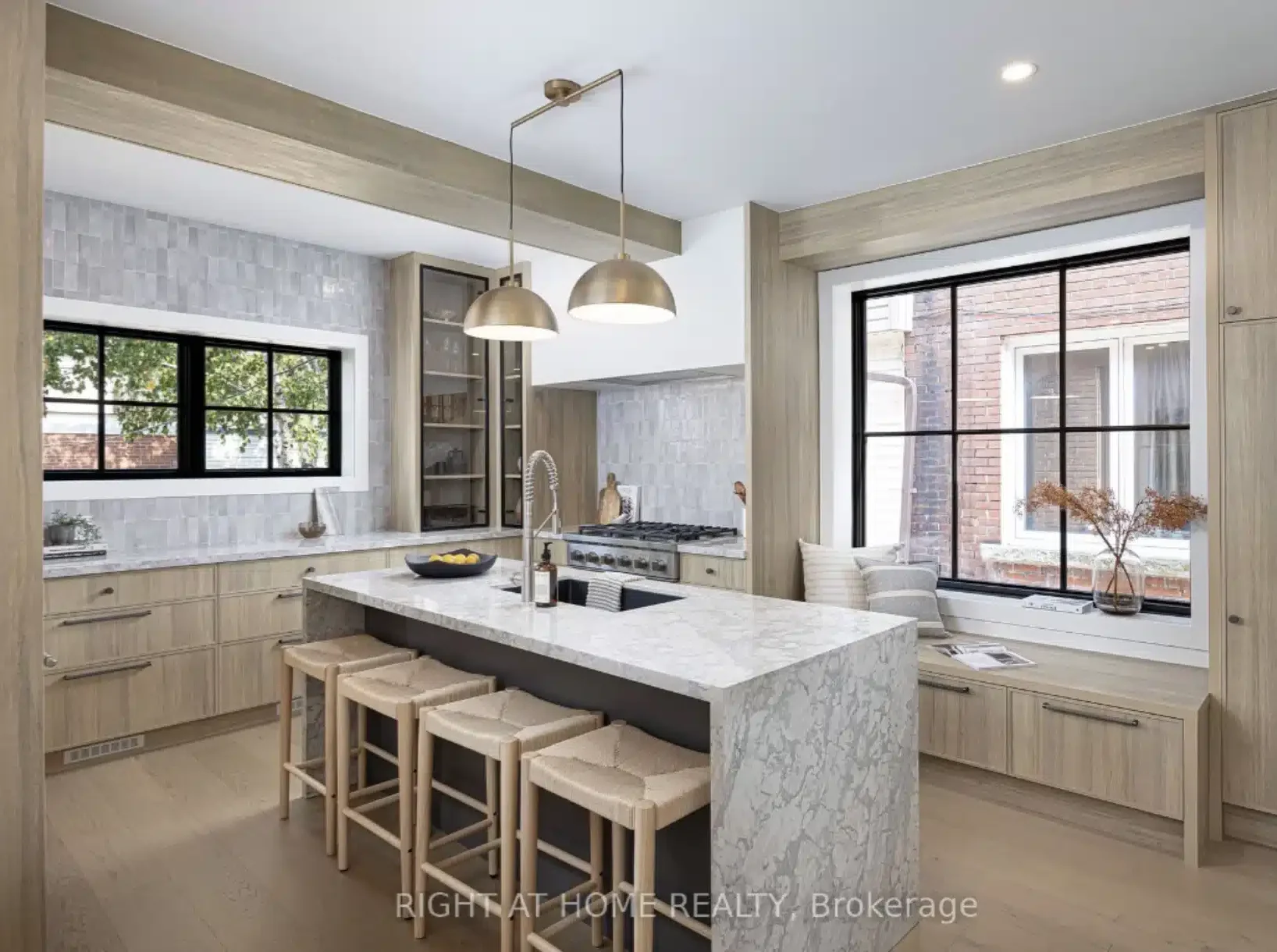 Remodeled custom kitchen featuring a large marble island and open layout after structural load bearing wall removals on a residential project.