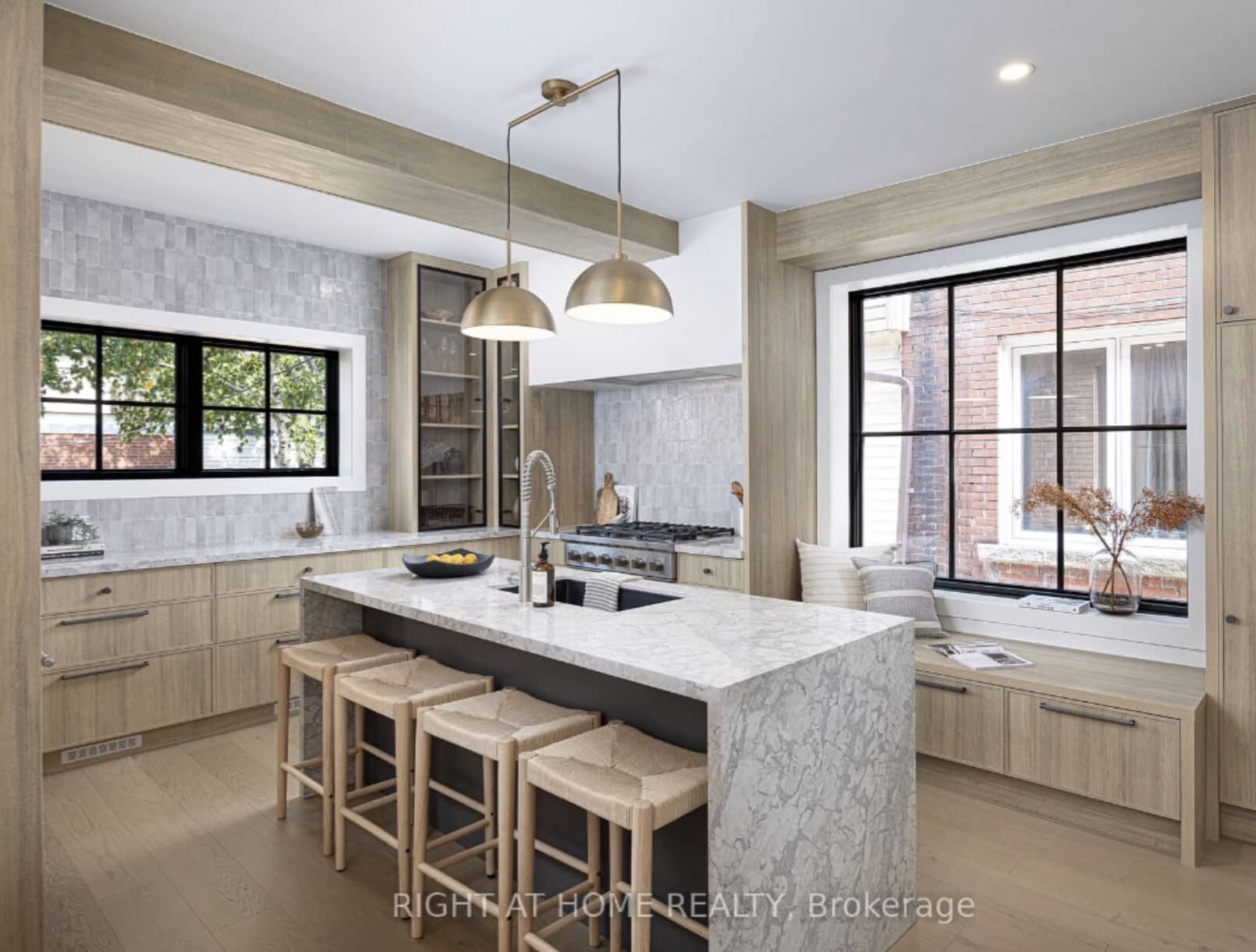 Remodeled custom kitchen featuring a large marble island and open layout after structural load bearing wall removals on a residential project.